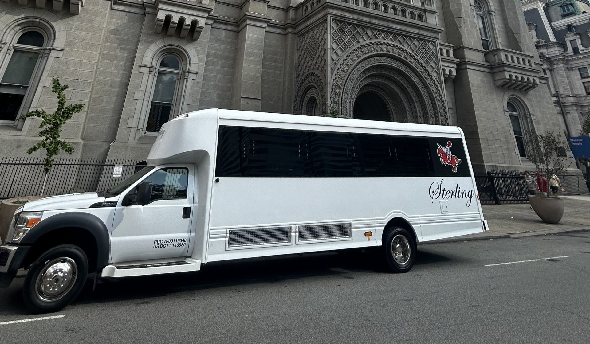 Limousine party bus in front of church