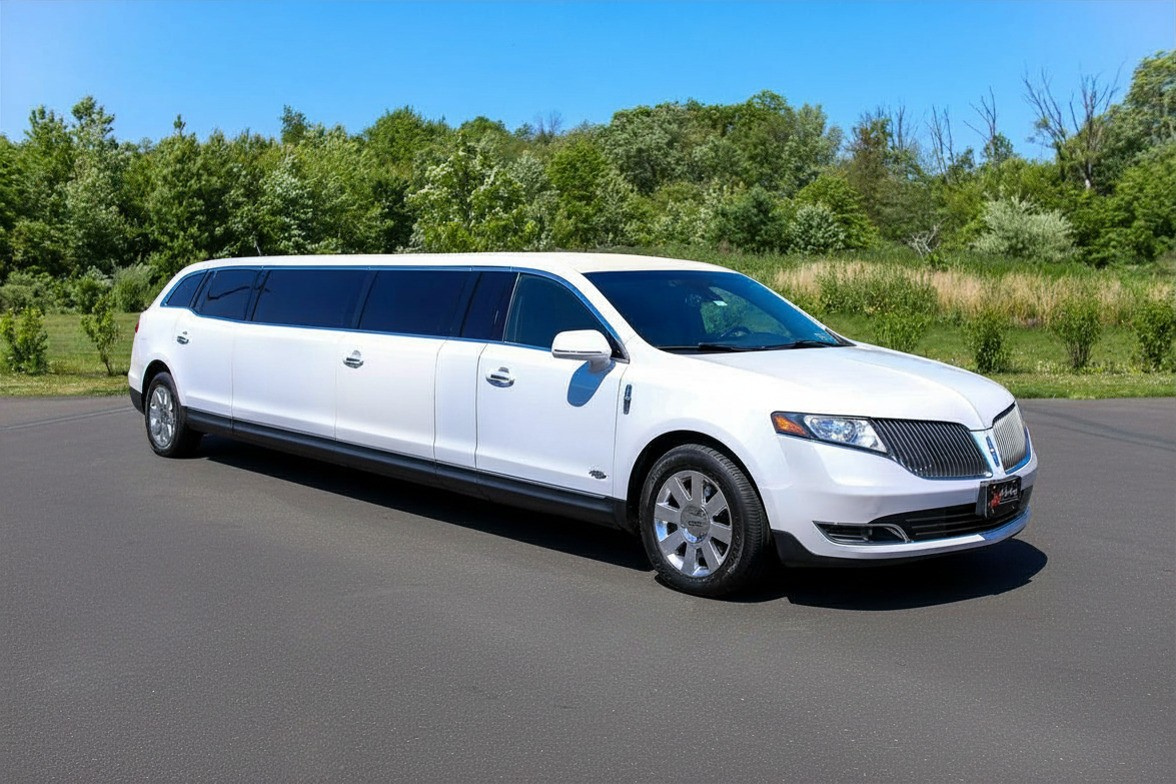 white stretch limousine outside in parking lot